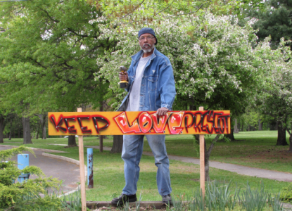 Naim Muslim putting up another keep love present sign in camden, nj